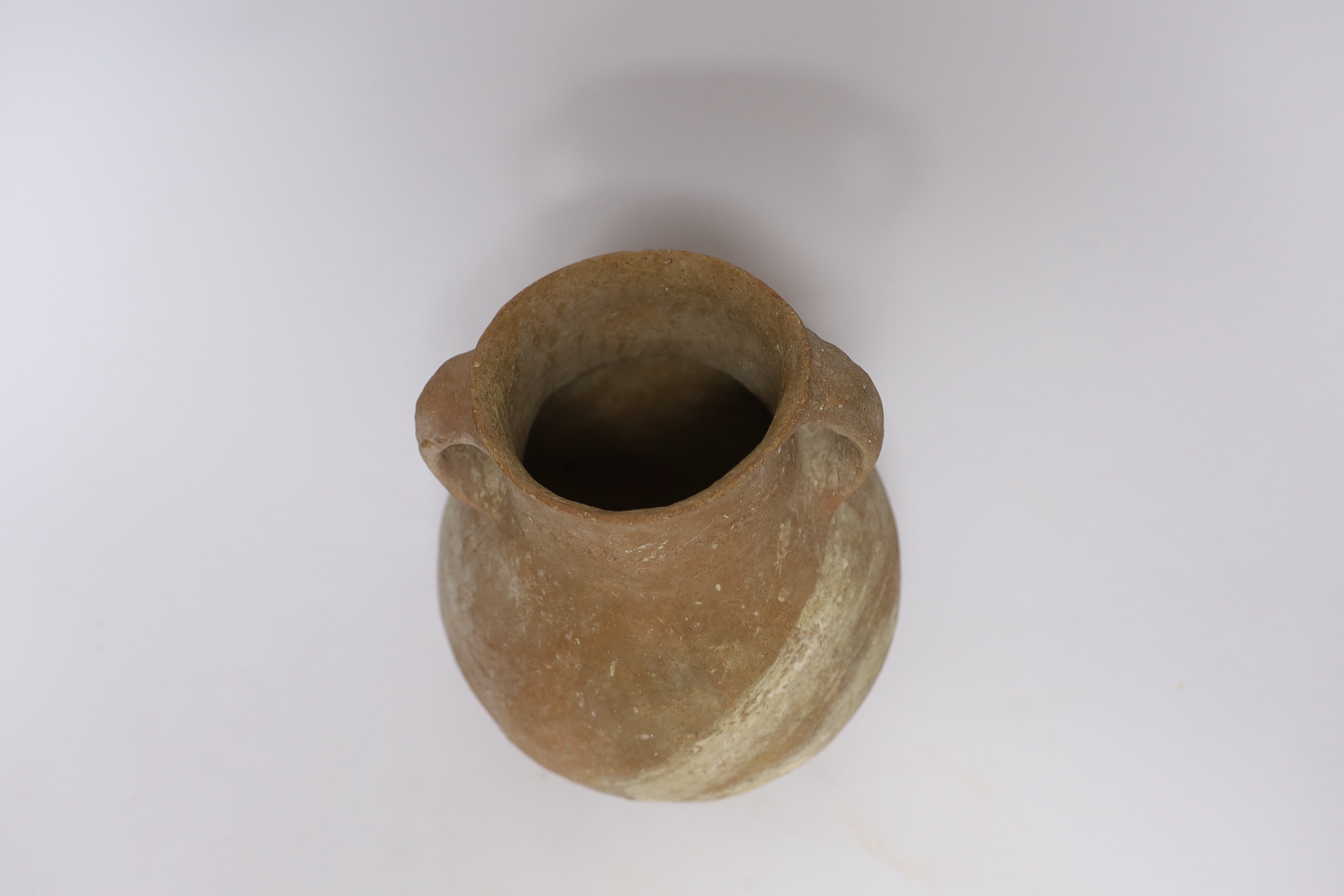 An intact Roman terracotta two handled jar, 17.5cm high